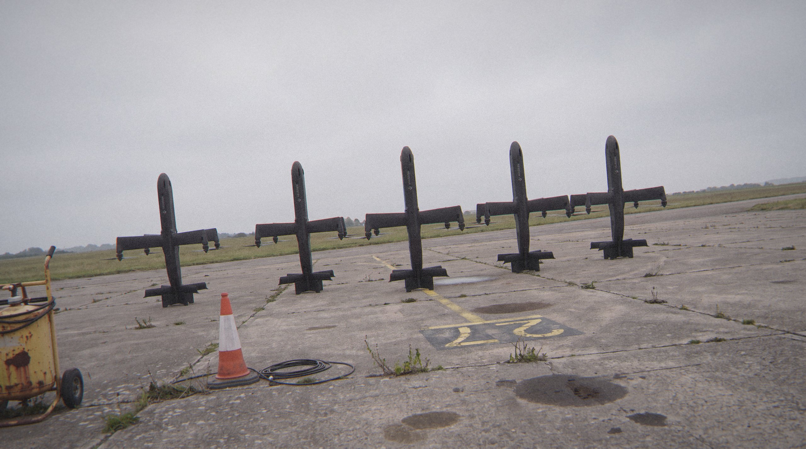 Vanguard interceptors standing on a wet airfield apron at dusk
