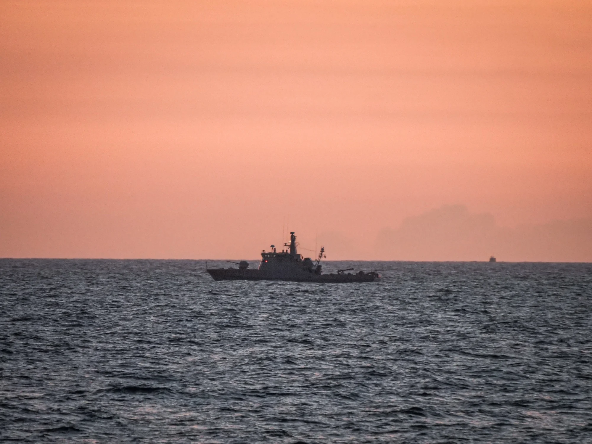 A naval vessel at dusk in the Baltic Sea during BALTOPS 25